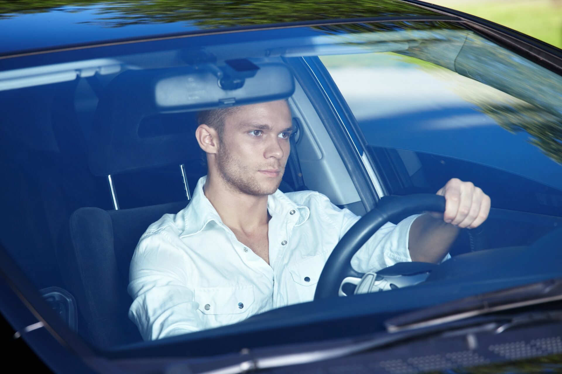 Homme attrayant derrière le volant de sa voiture