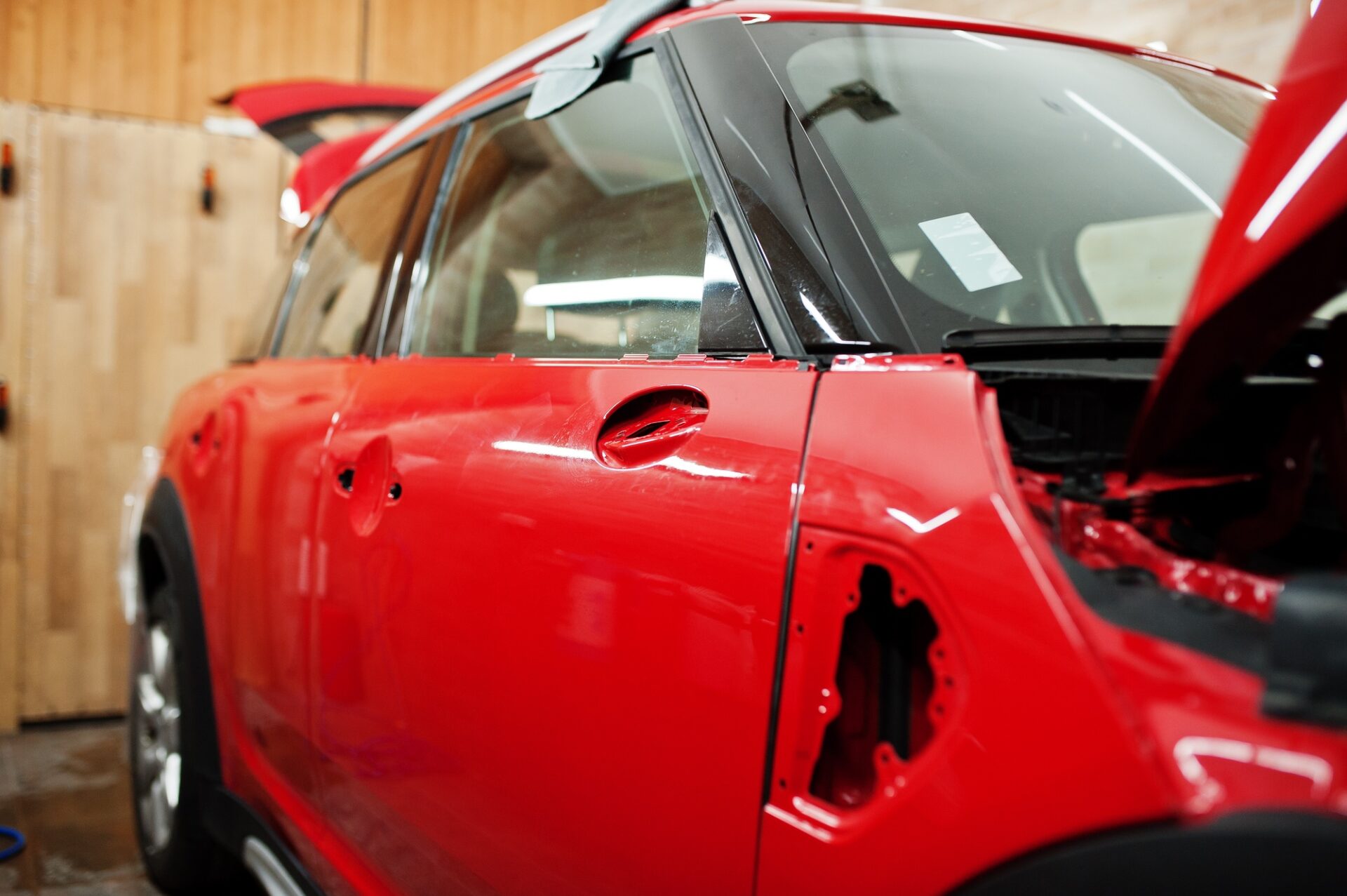 Carrosserie rouge du service de voiture à l'atelier de détail des véhicules.